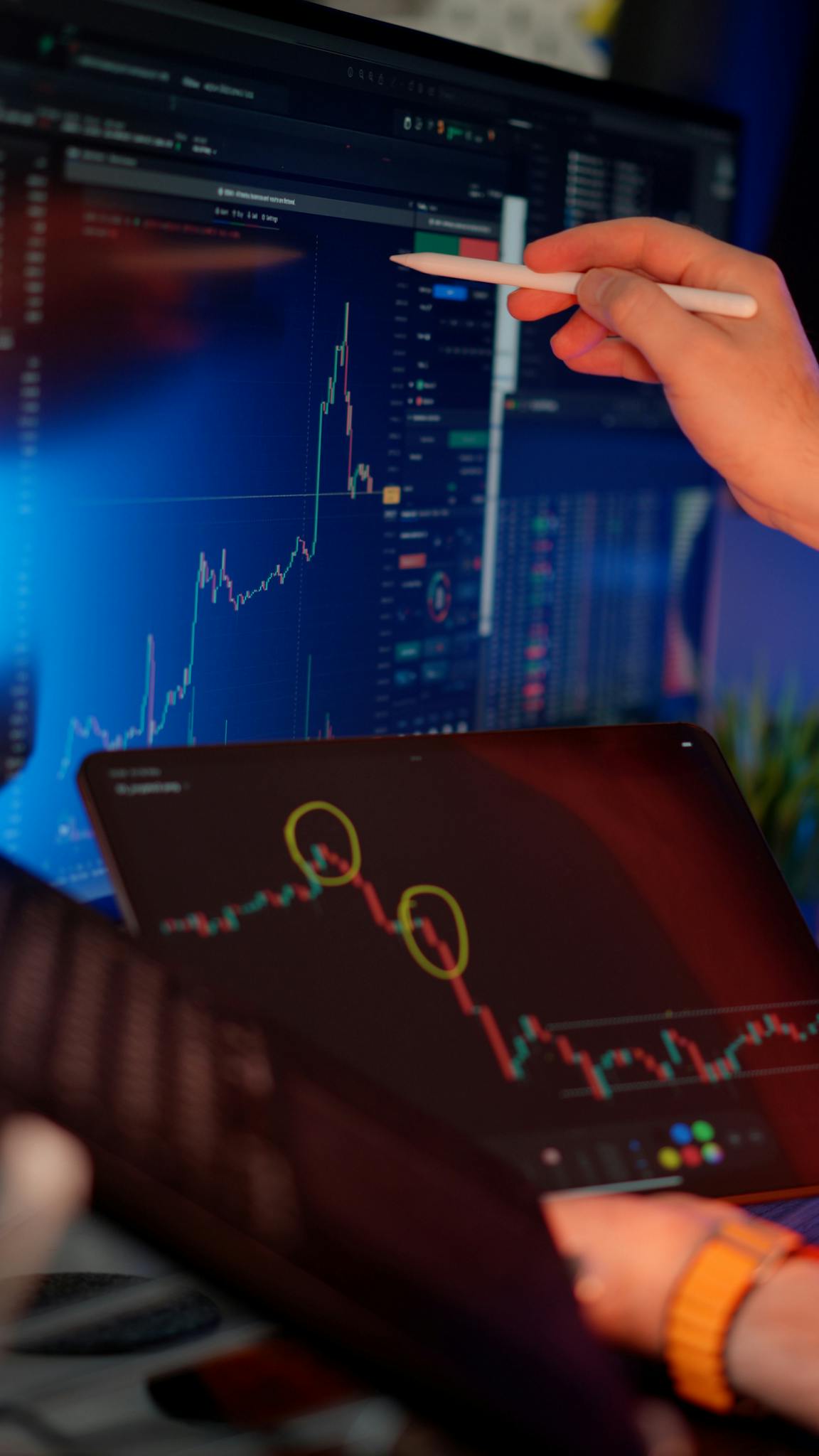 A person analyzes cryptocurrency market trends on multiple screens with graphs.